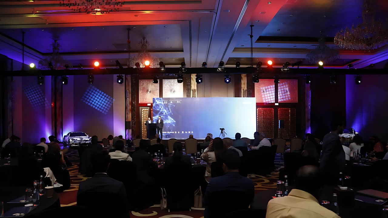 A summit ballroom set with round tables during an evening session
